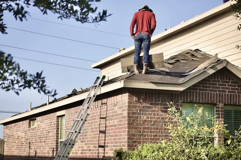 Professional roofer working on a residential roof in Hillside